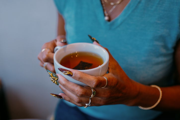 Woman Drinking Tea for a Burn and Brew Ritual