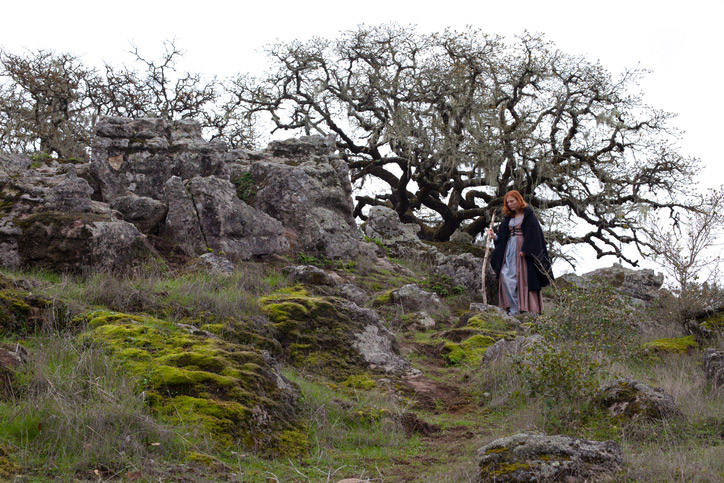 Witch walking with stang in Scottish Highlands